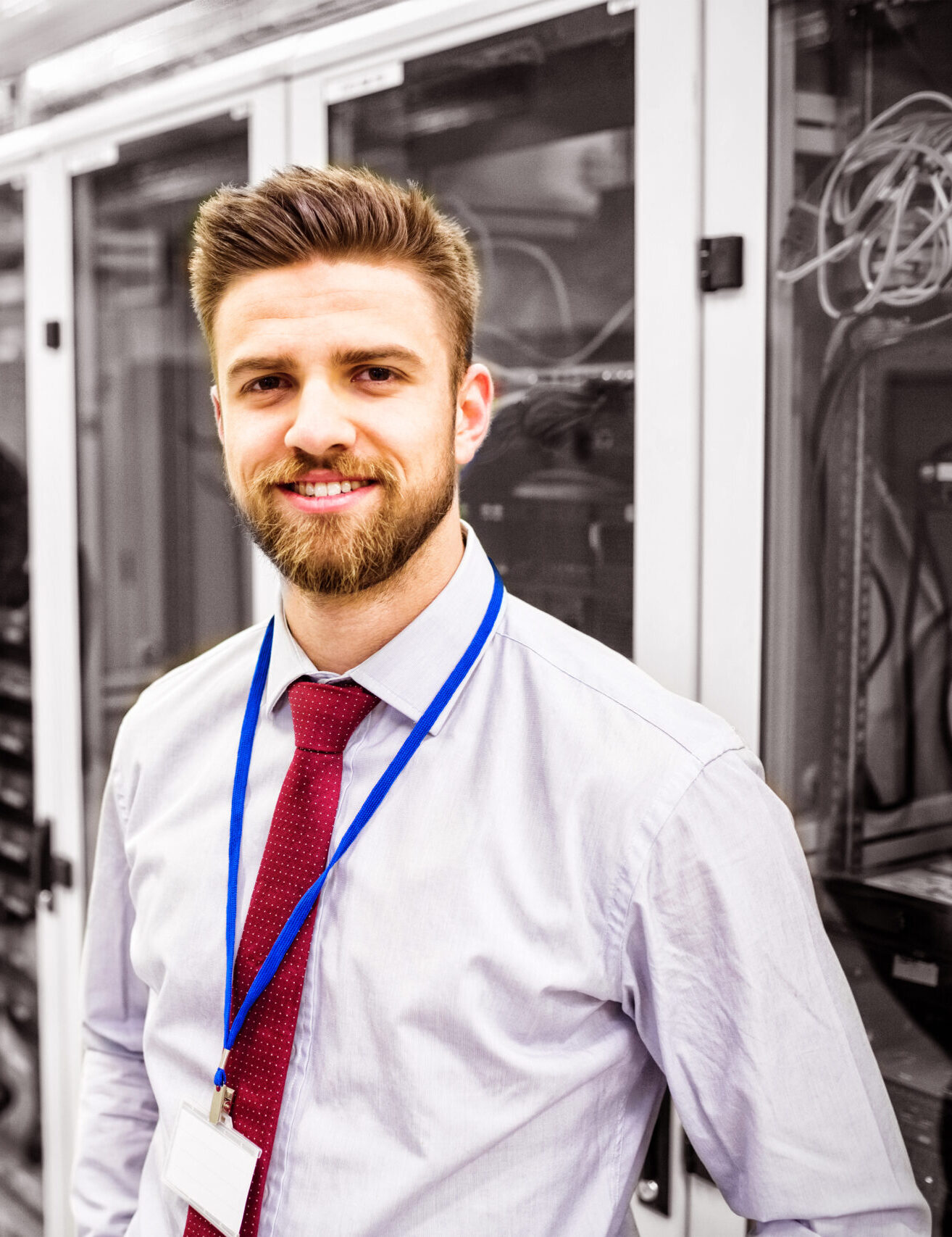 Smiling technician standing in a server room