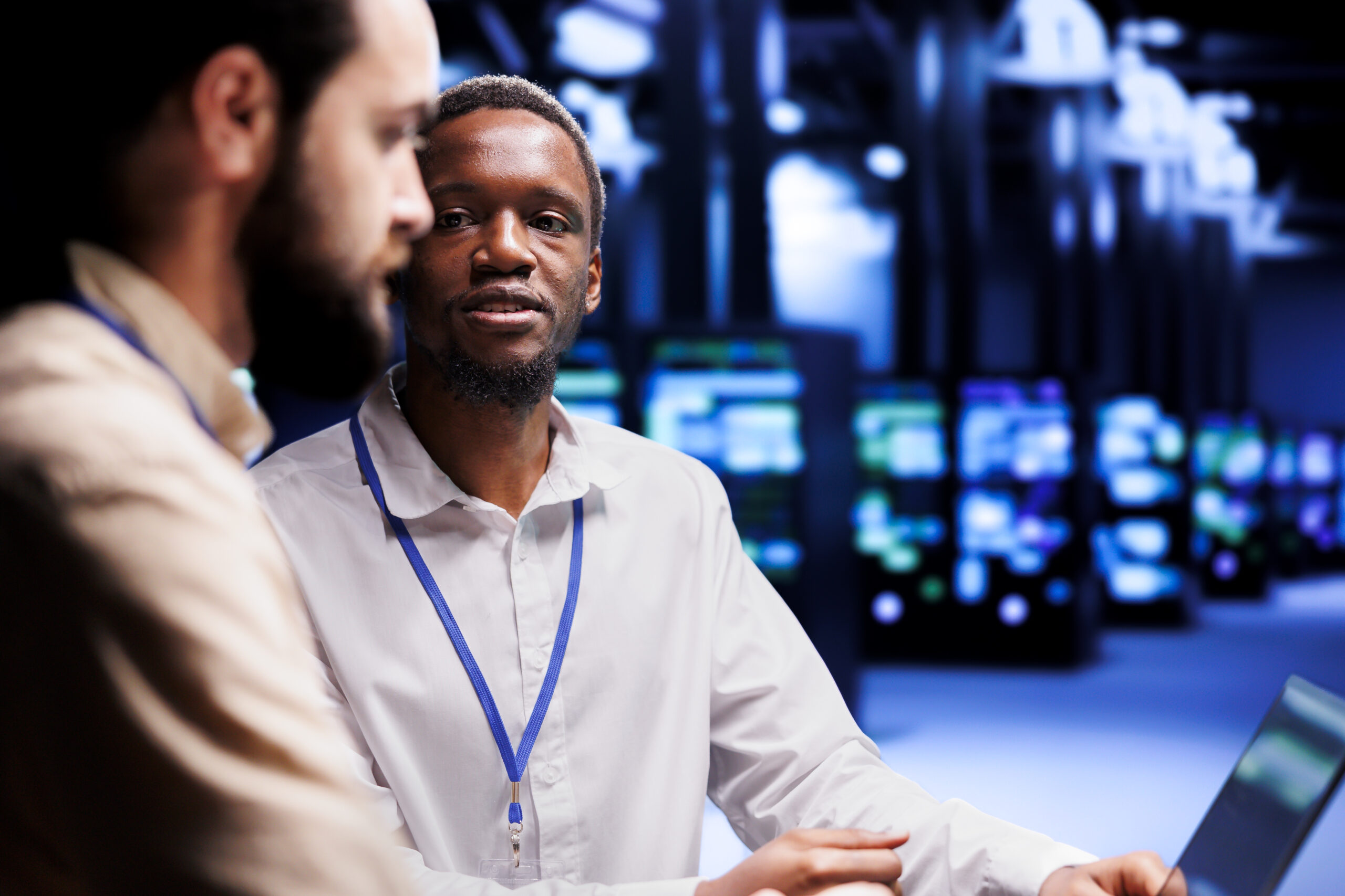 Teamworking IT developers dealing with server hub system failures. Programmers brainstorming ideas on how to best minimize high tech data center downtime and prevent crashes